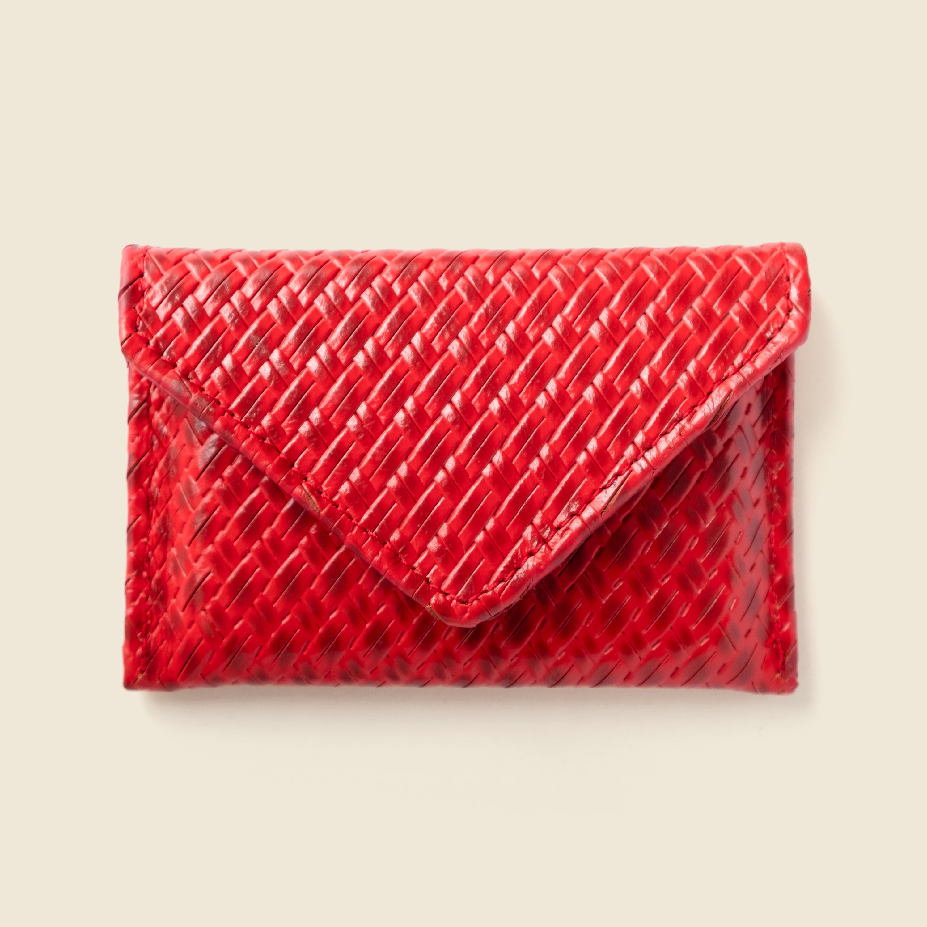 Red textured clutch on a beige background