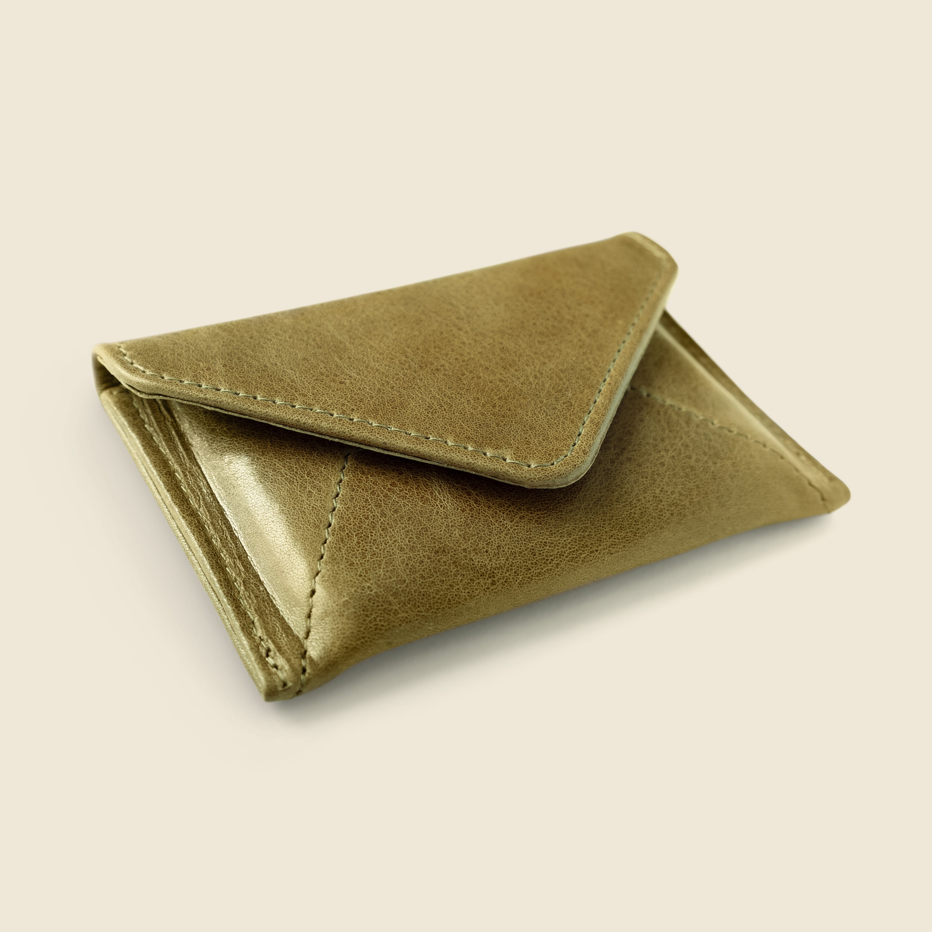 Brown leather wallet on a beige background
