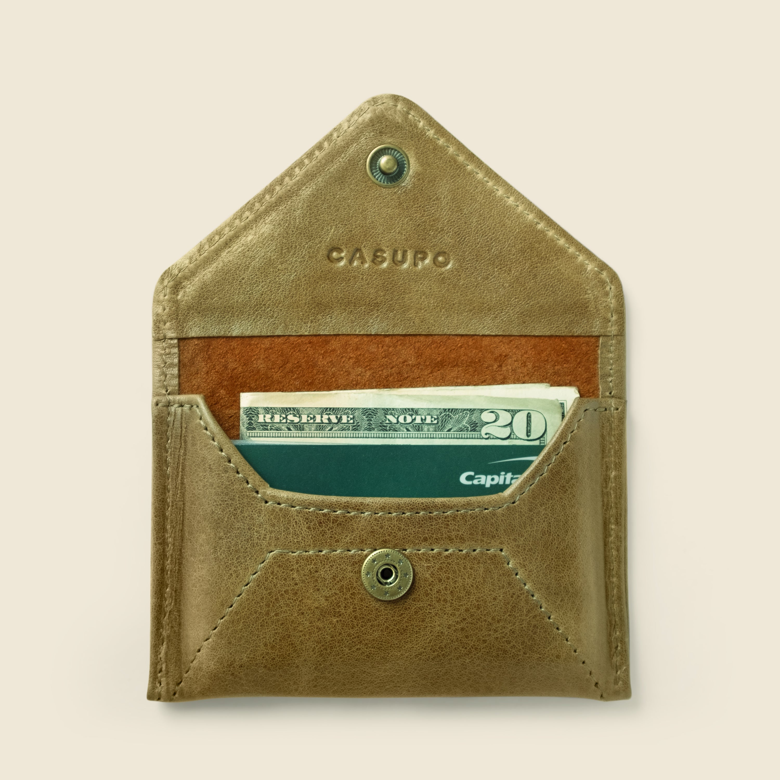 Brown leather wallet with money on a beige background