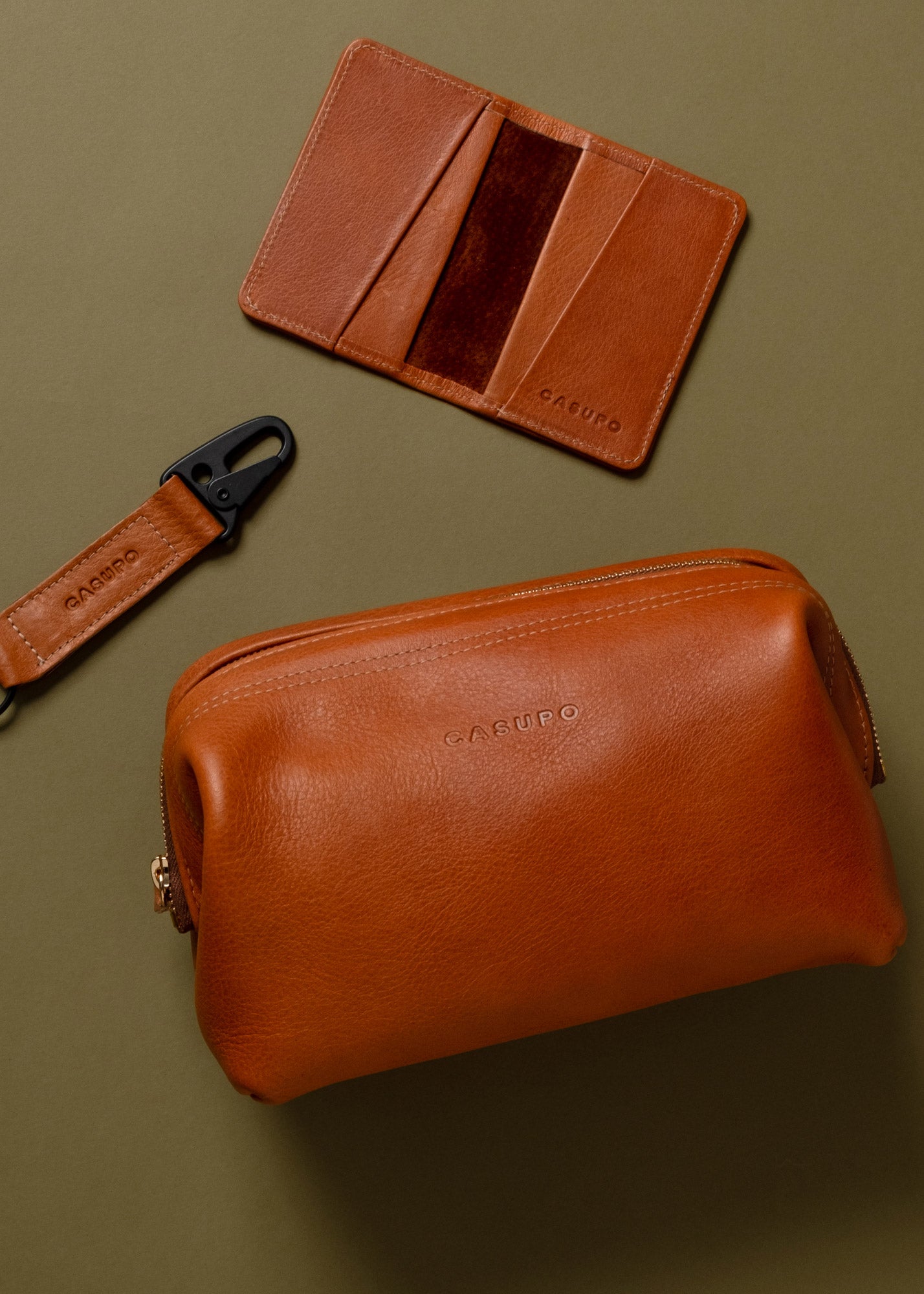 bundle of toiletry bag, keychain and bifold wallet