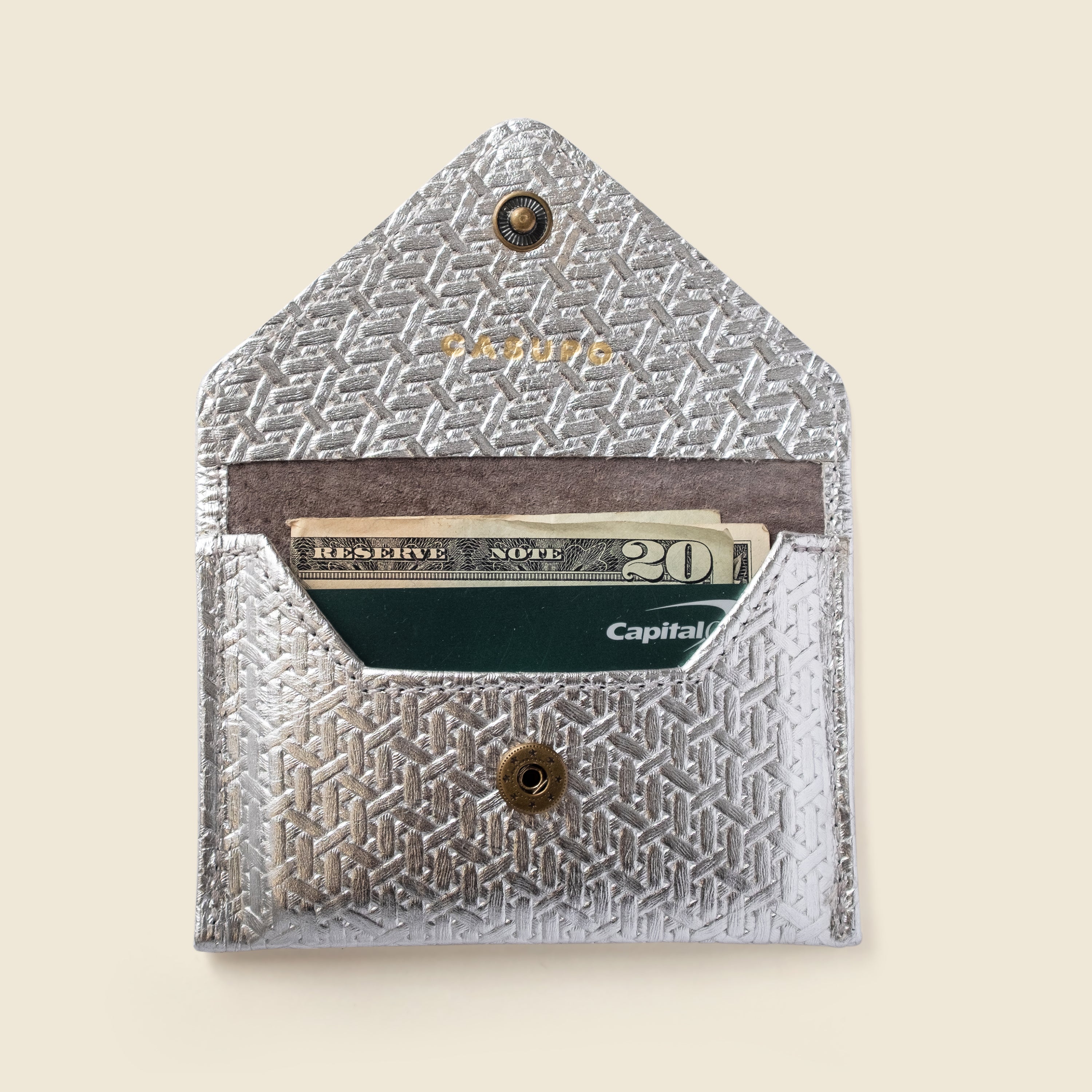 Patterned cardholder with cards inside on a beige background