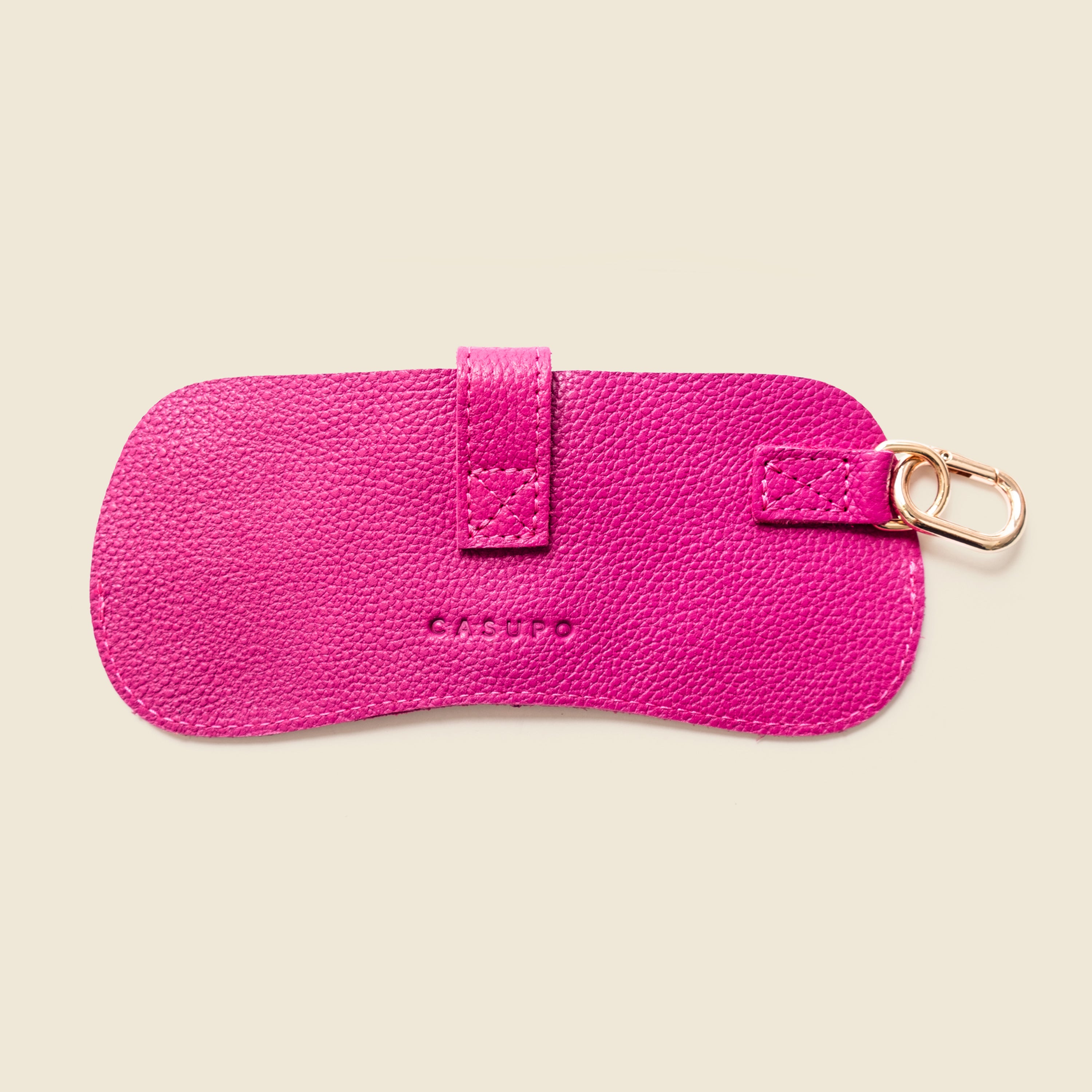 Pink leather case with a keychain on a white background