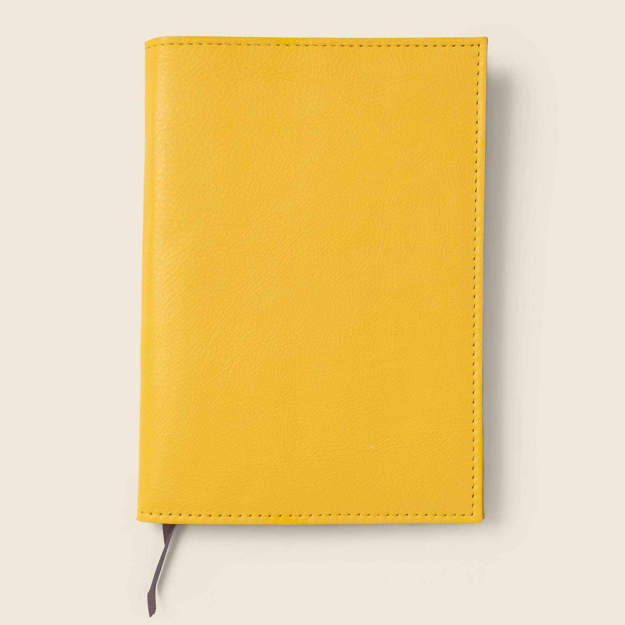 yellow leather notebook cover with lined notebook. refillable and customizable