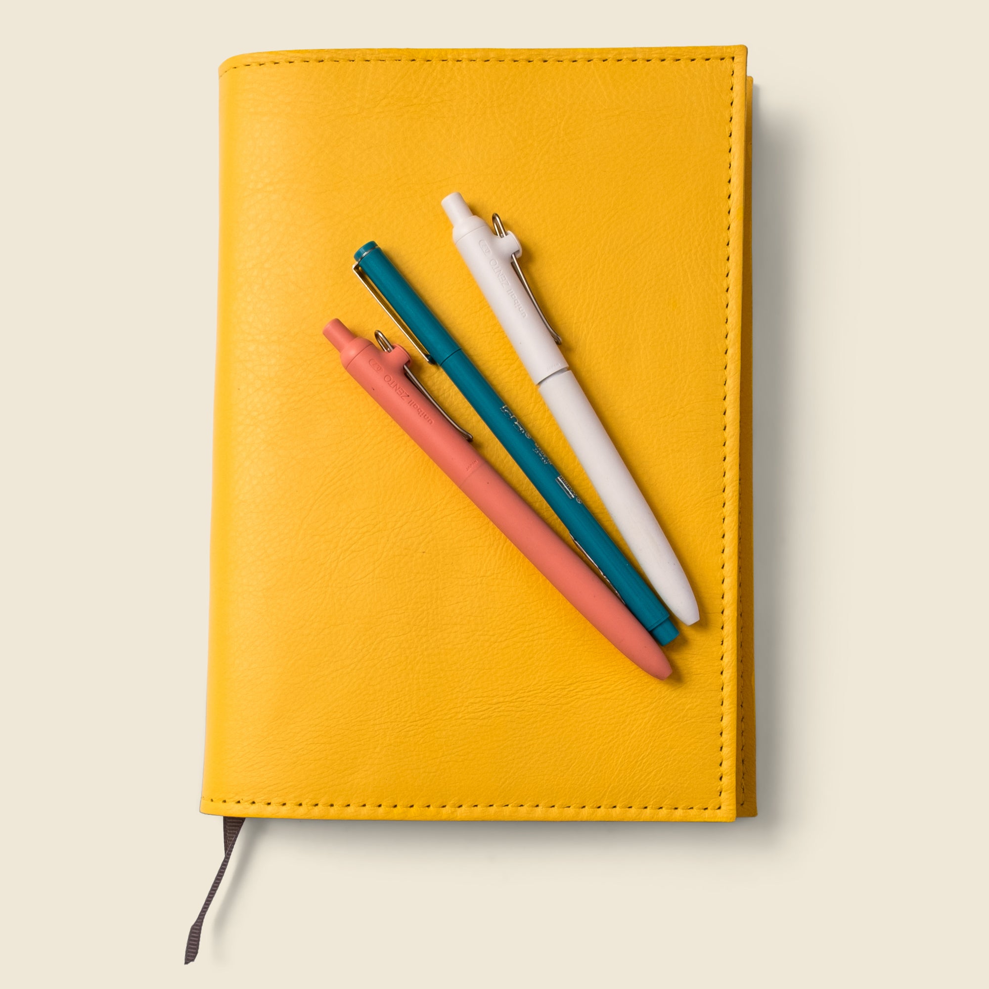 yellow leather notebook cover with lined notebook. refillable and customizable