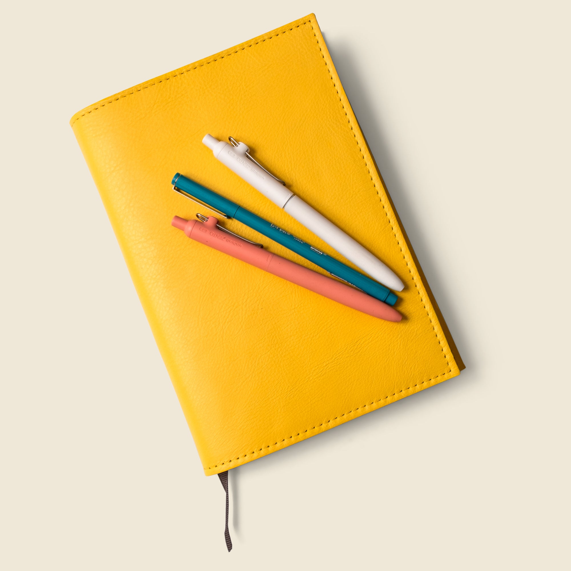 premium yellow leather notebook cover with lined notebook. refillable and customizable