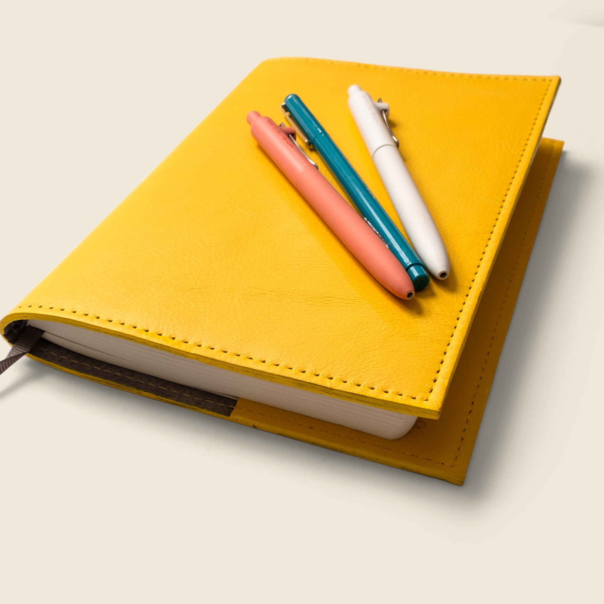 colorful yellow leather notebook cover with lined notebook. refillable and customizable