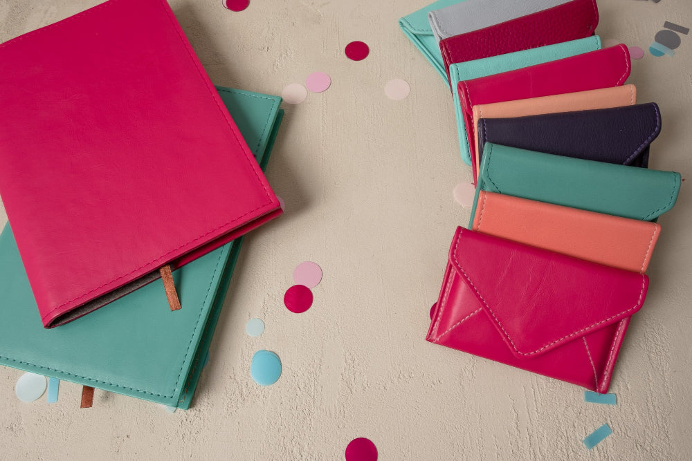 Colorful leather wallets on a light surface with confetti