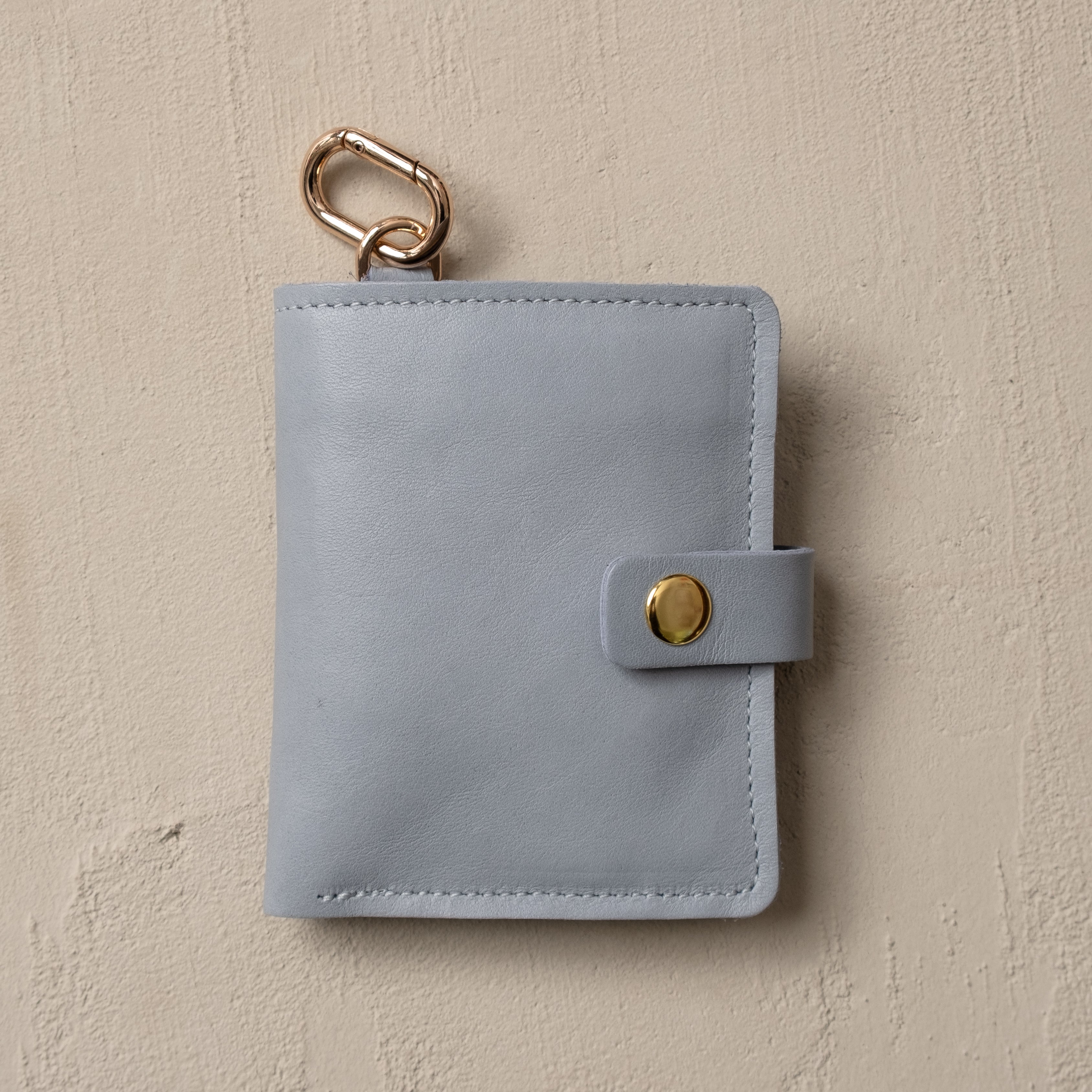 Ice blue leather wallet with key ring — side profile view