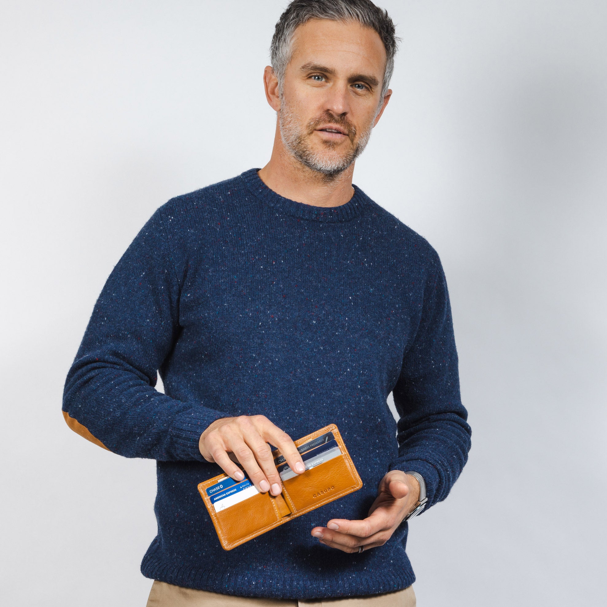 A man holding a Chocolate Large Billfold Wallet with RFID protection - Casupo