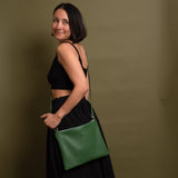 woman wearing green leather crossbody bag