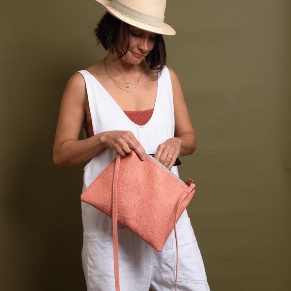 woman wearing pink leather crossbody bag