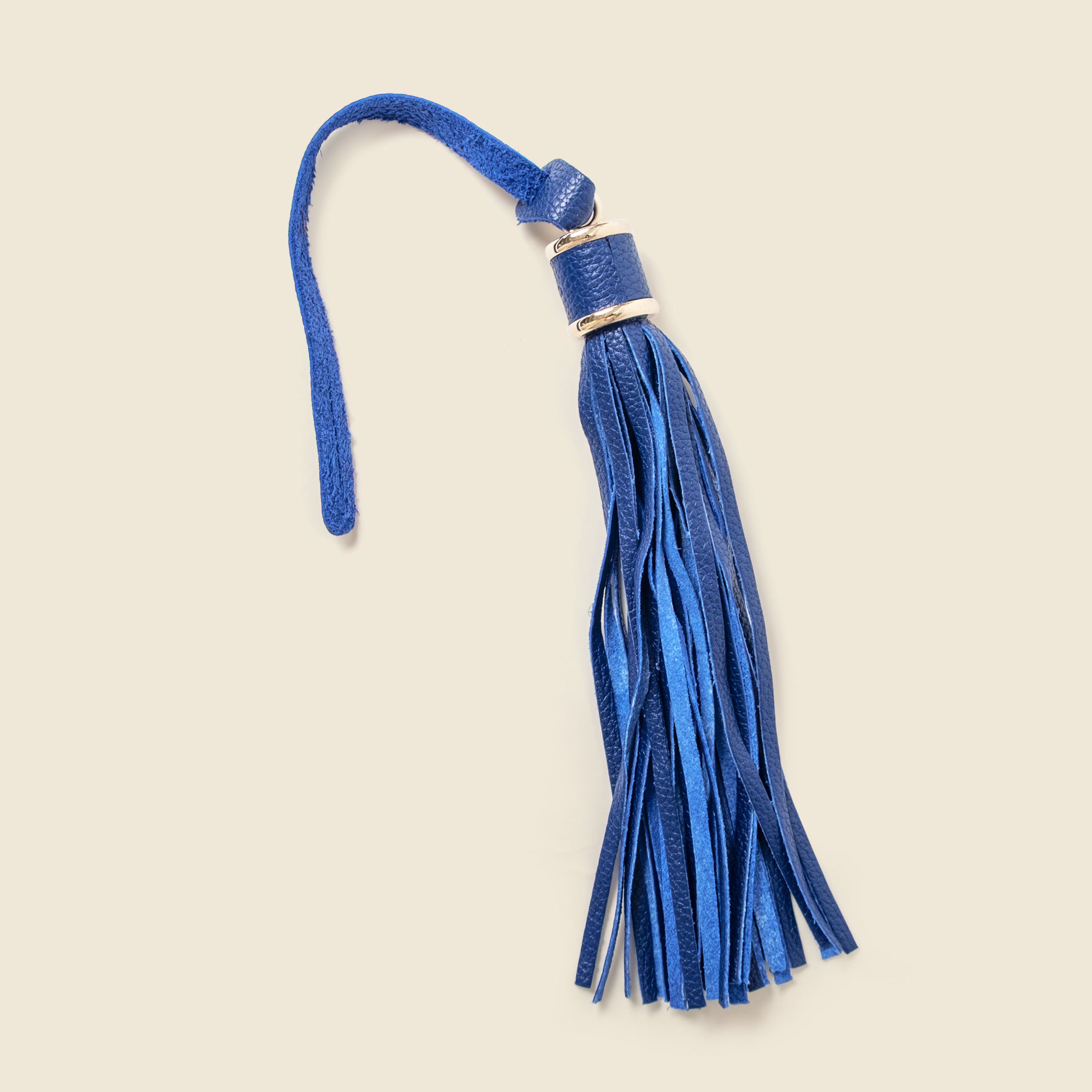 Blue tassel on a beige background
