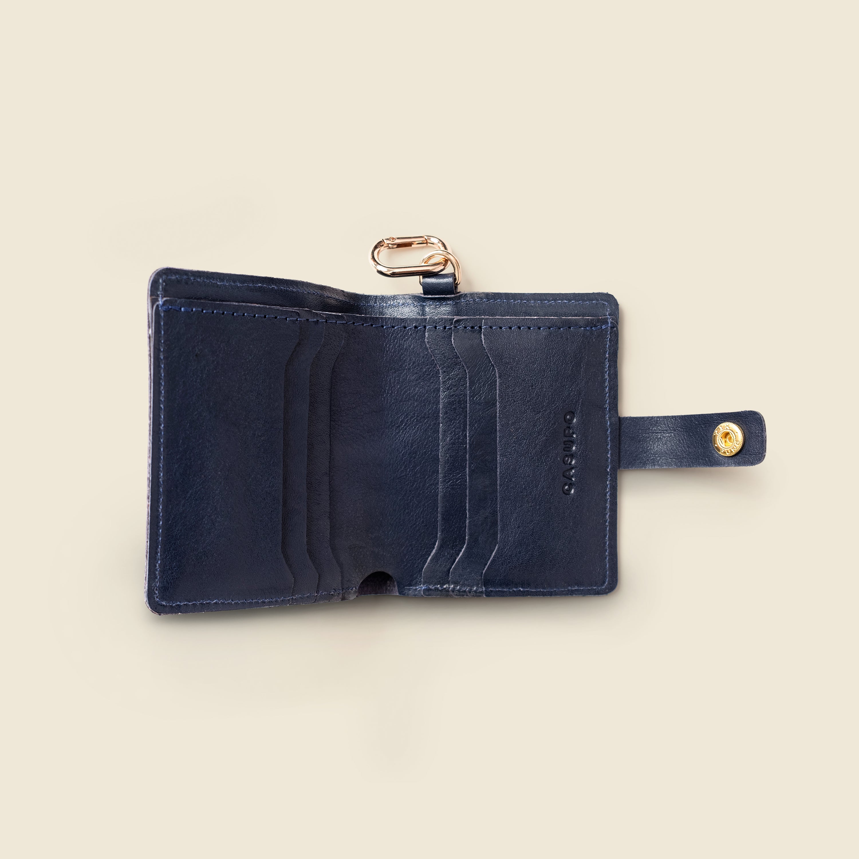 Marine blue leather wallet with key ring, front view on neutral background