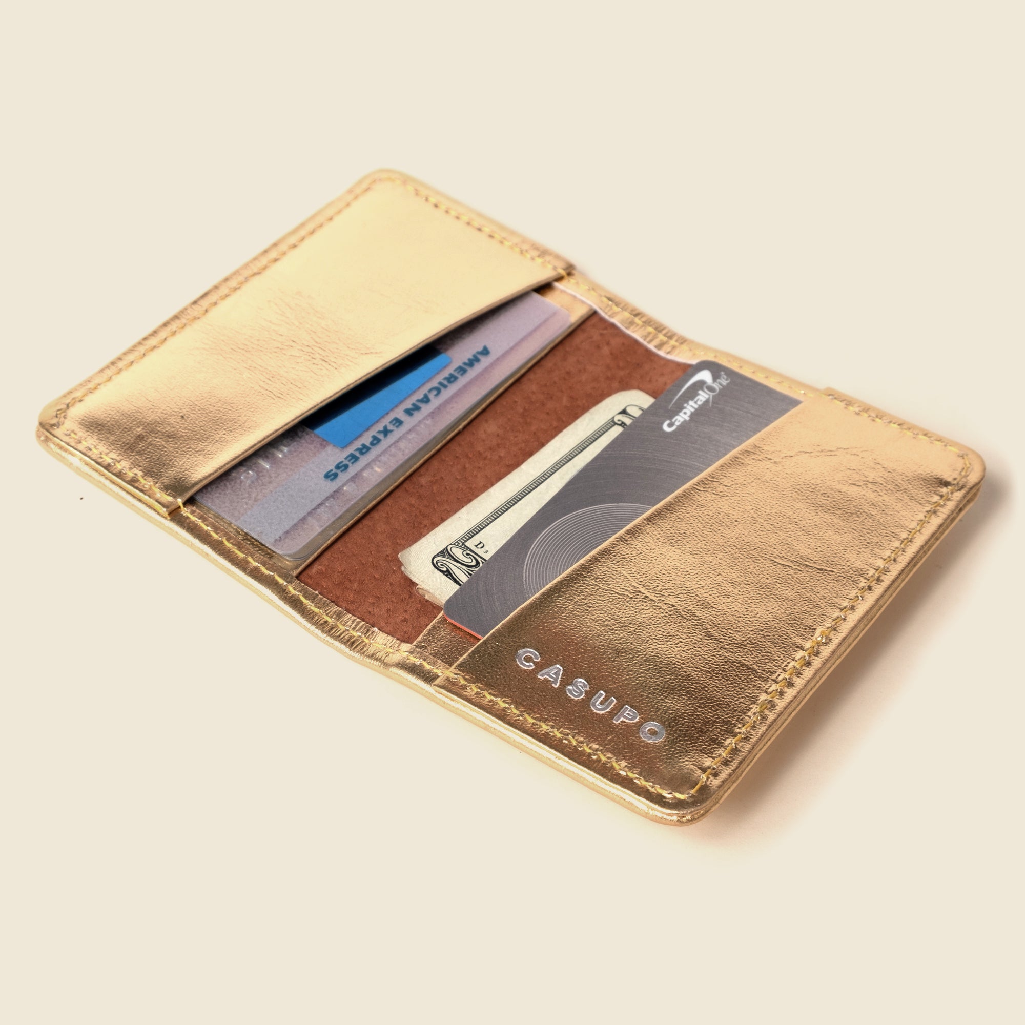 shiny gold leather bifold wallet with RFID blocking