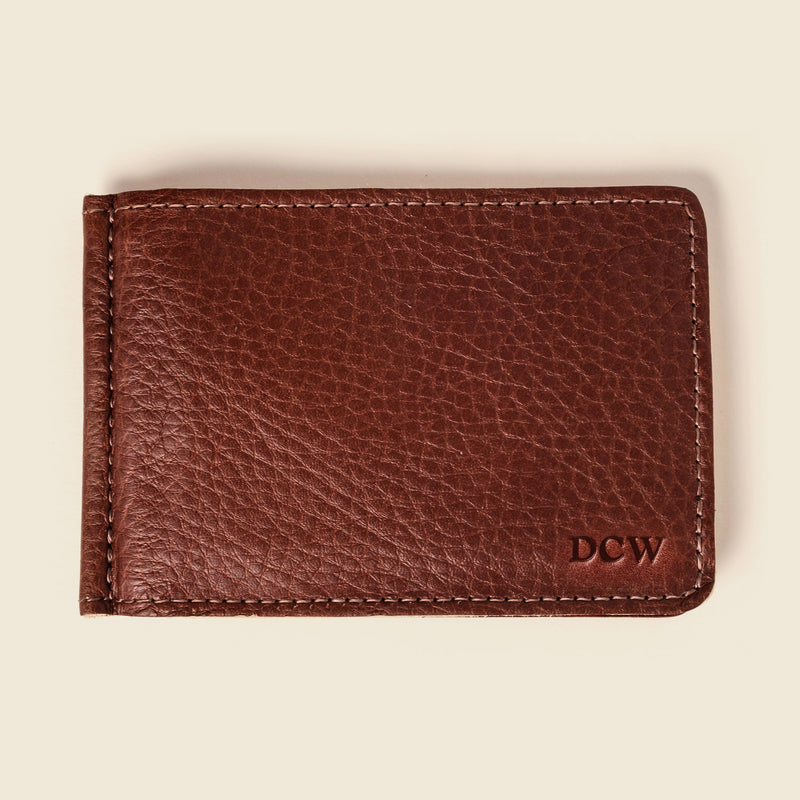 Brown money clip wallet with DCW letters monogrammed on the bottom right corner