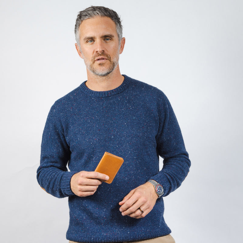Model holding brown leather wallet